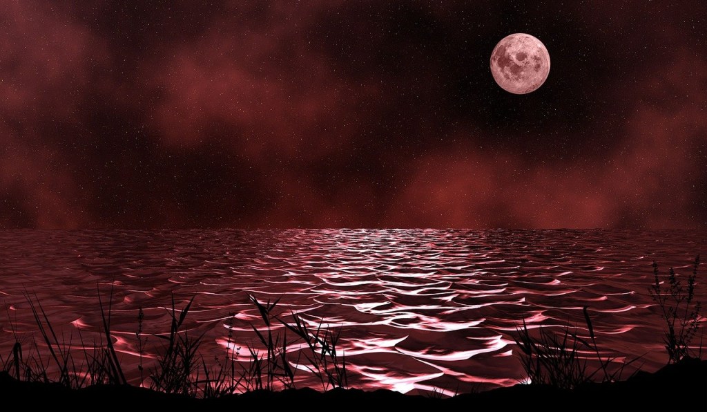 Poetry Red blood body of water the tips of the waves highlighted by the reflection of a blood red moon in a black sky with clouds tinged in red