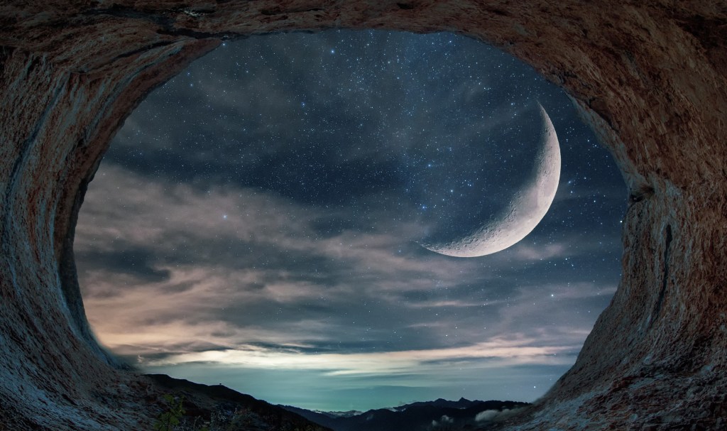 Poem Poety An opening of a rocky enclosure looking out onto a water body with the sky lit in stars twinkling through the clouds, and a large smiling crescent moon hanging in the night