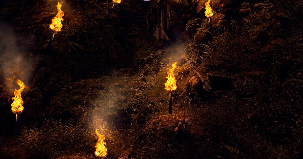 Poetry Flaming torches lighting up along the stone walls of a ruin